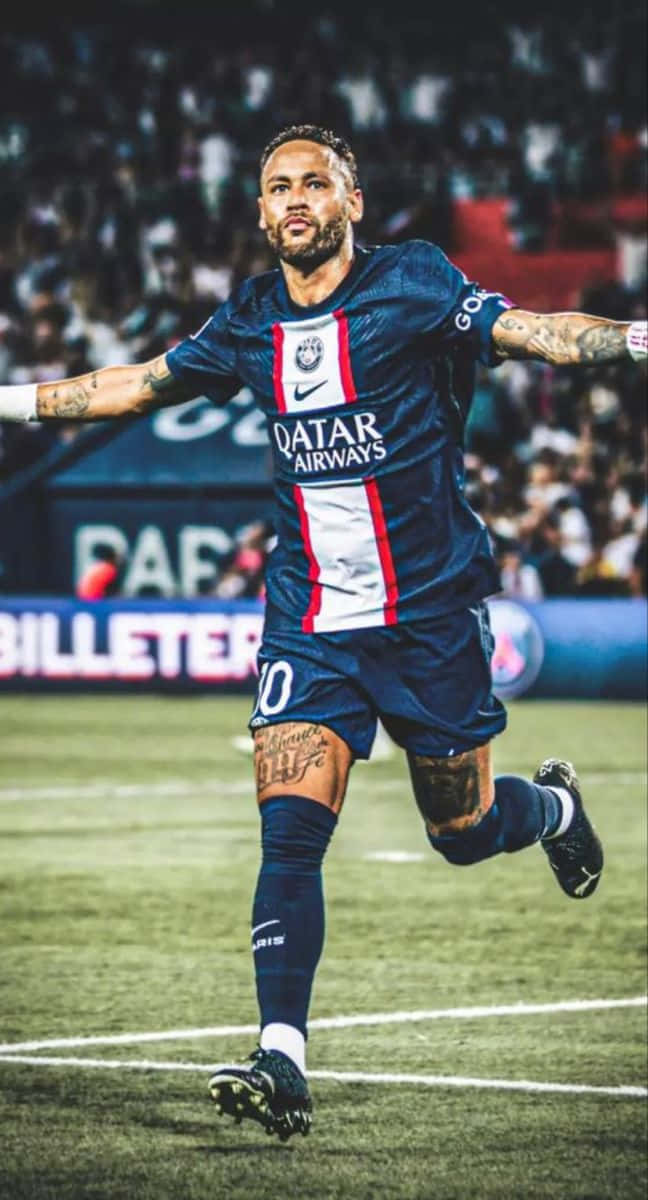 En fodboldspiller løber på en bane Wallpapers