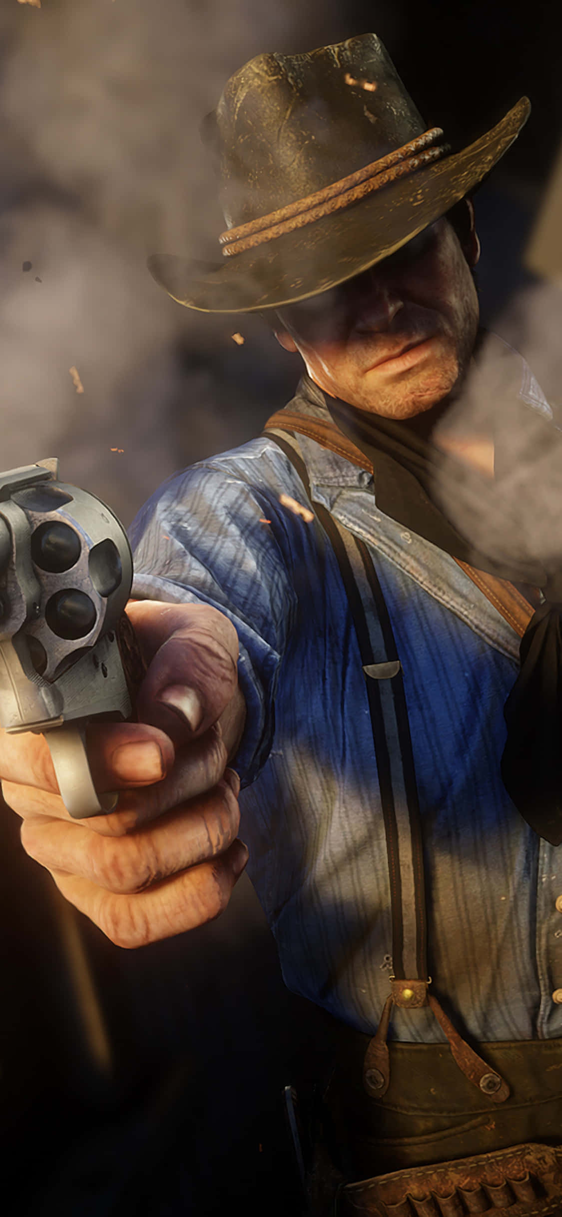 en mand i cowboyhat holder en pistol Wallpapers