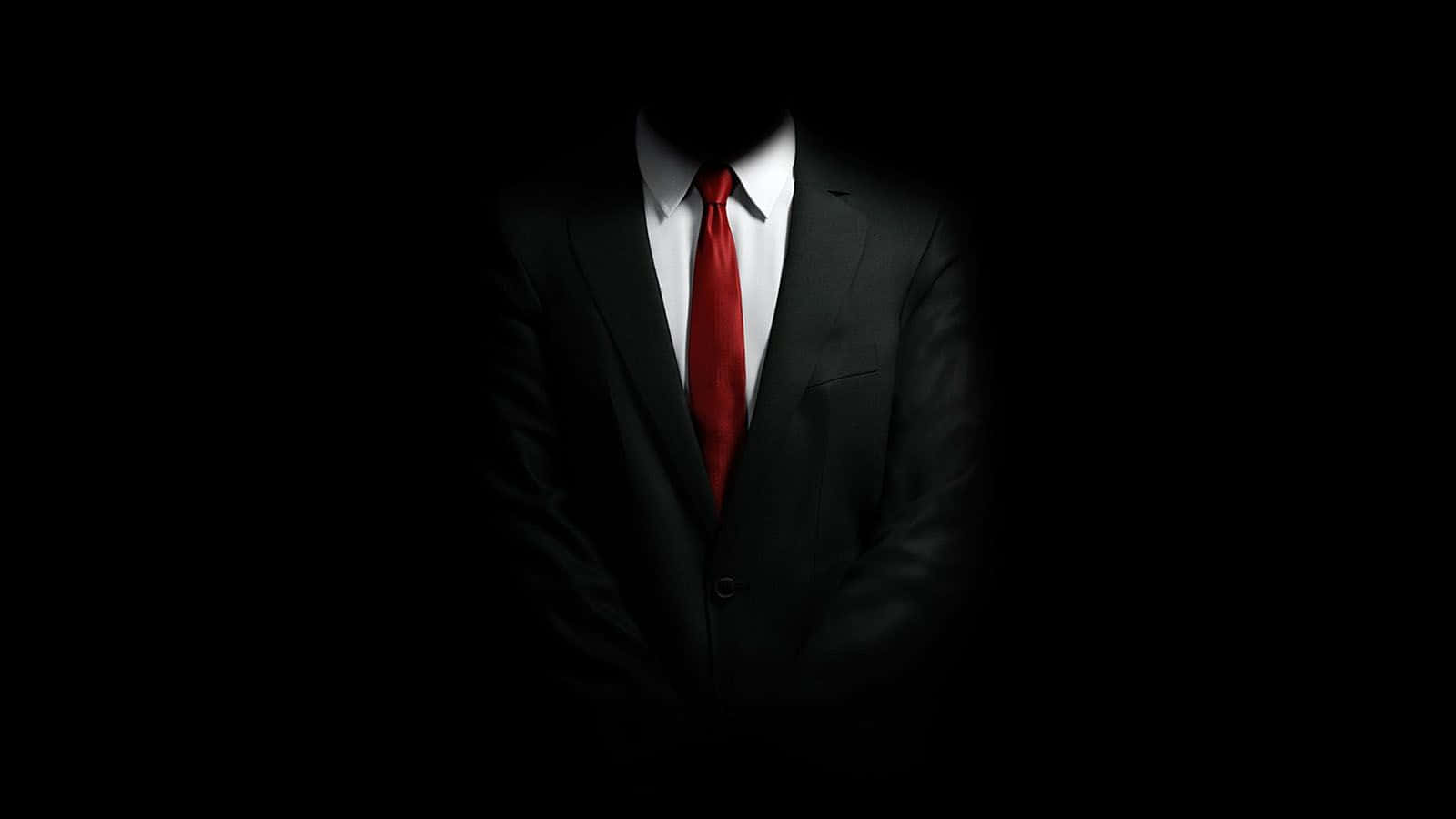 en mand i jakkesæt og slips står i mørket Wallpapers