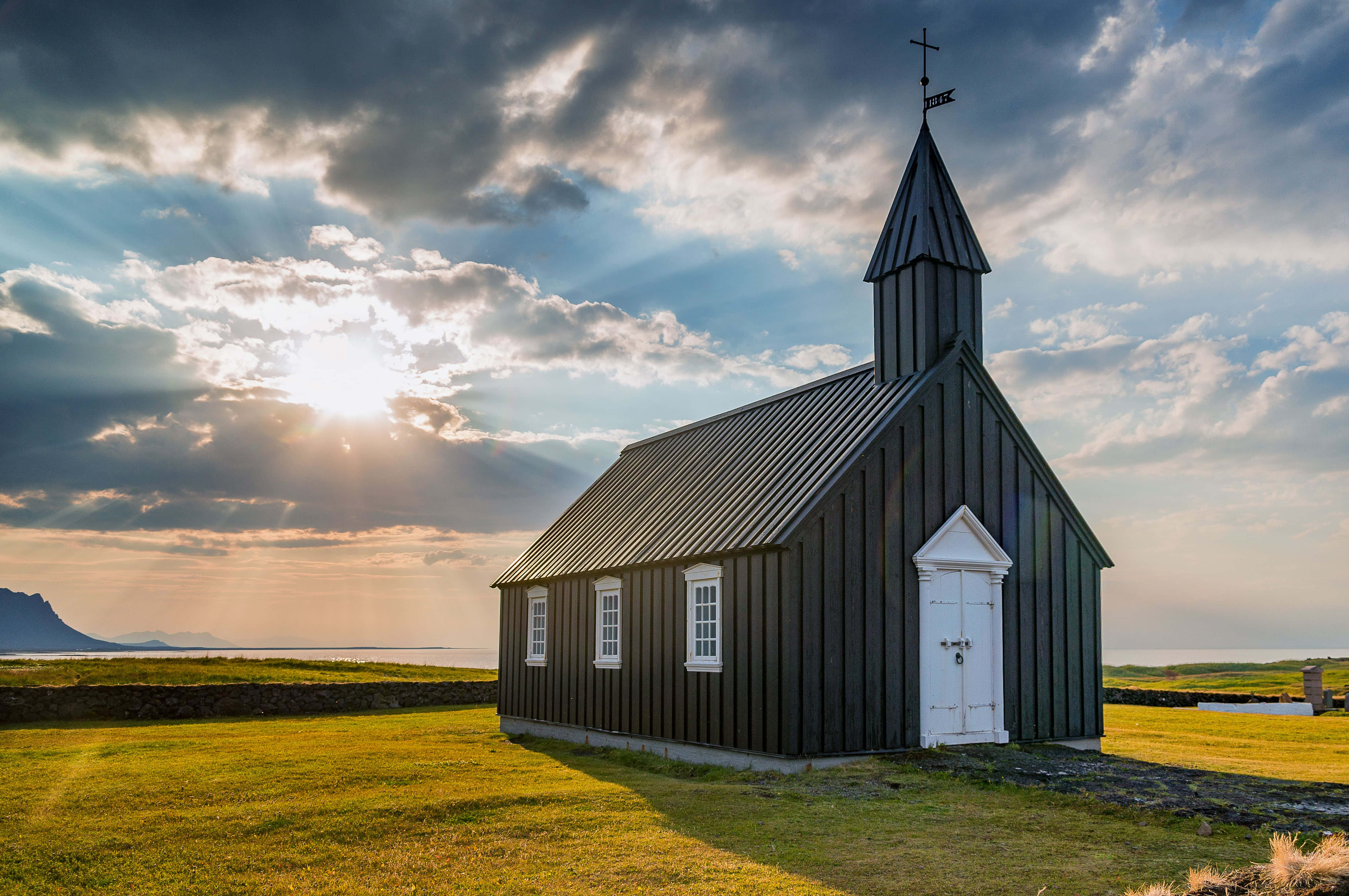 en sort kirke står på en græsmark Wallpapers