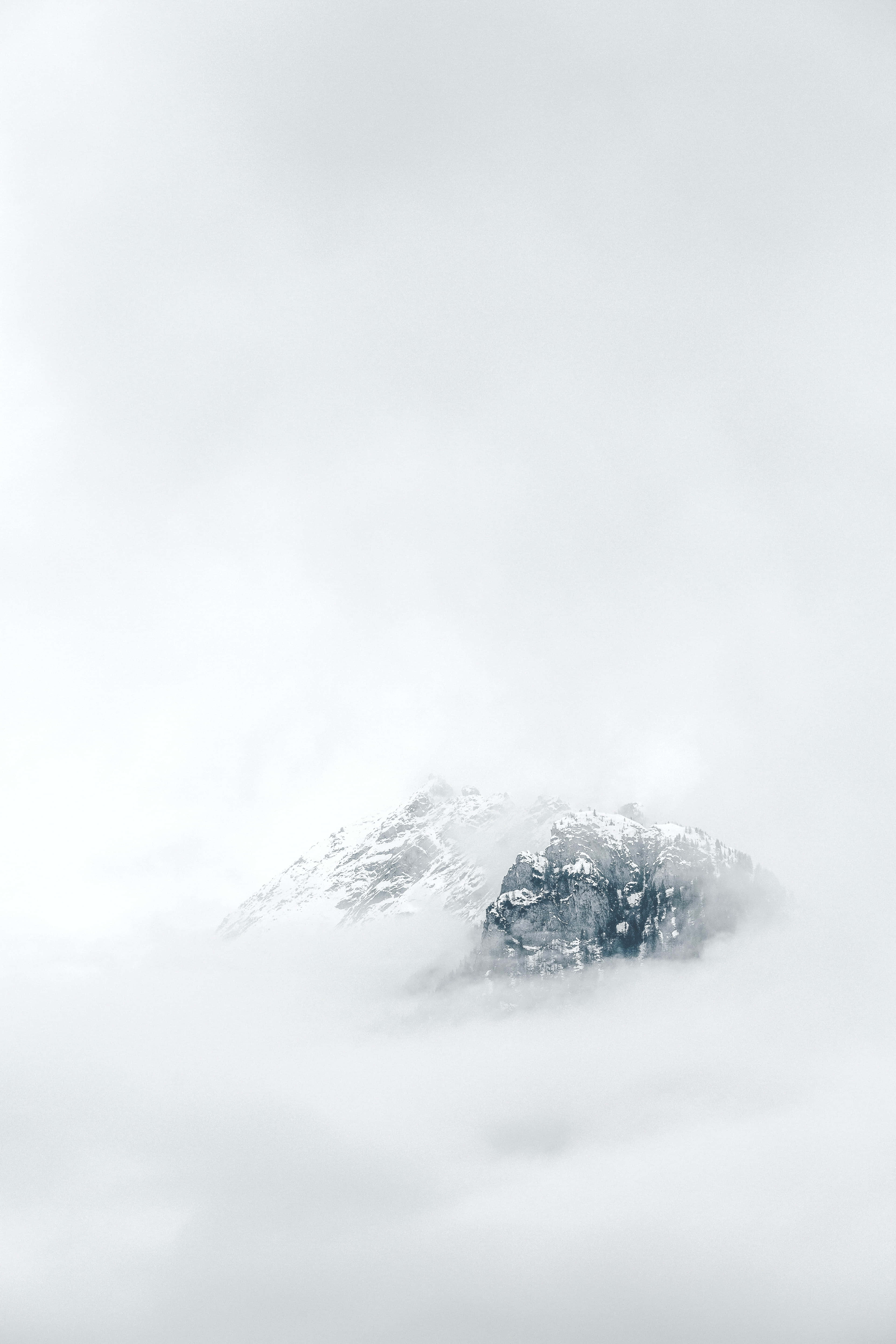 et bjerg dækket af skyer med sne på toppen Wallpapers