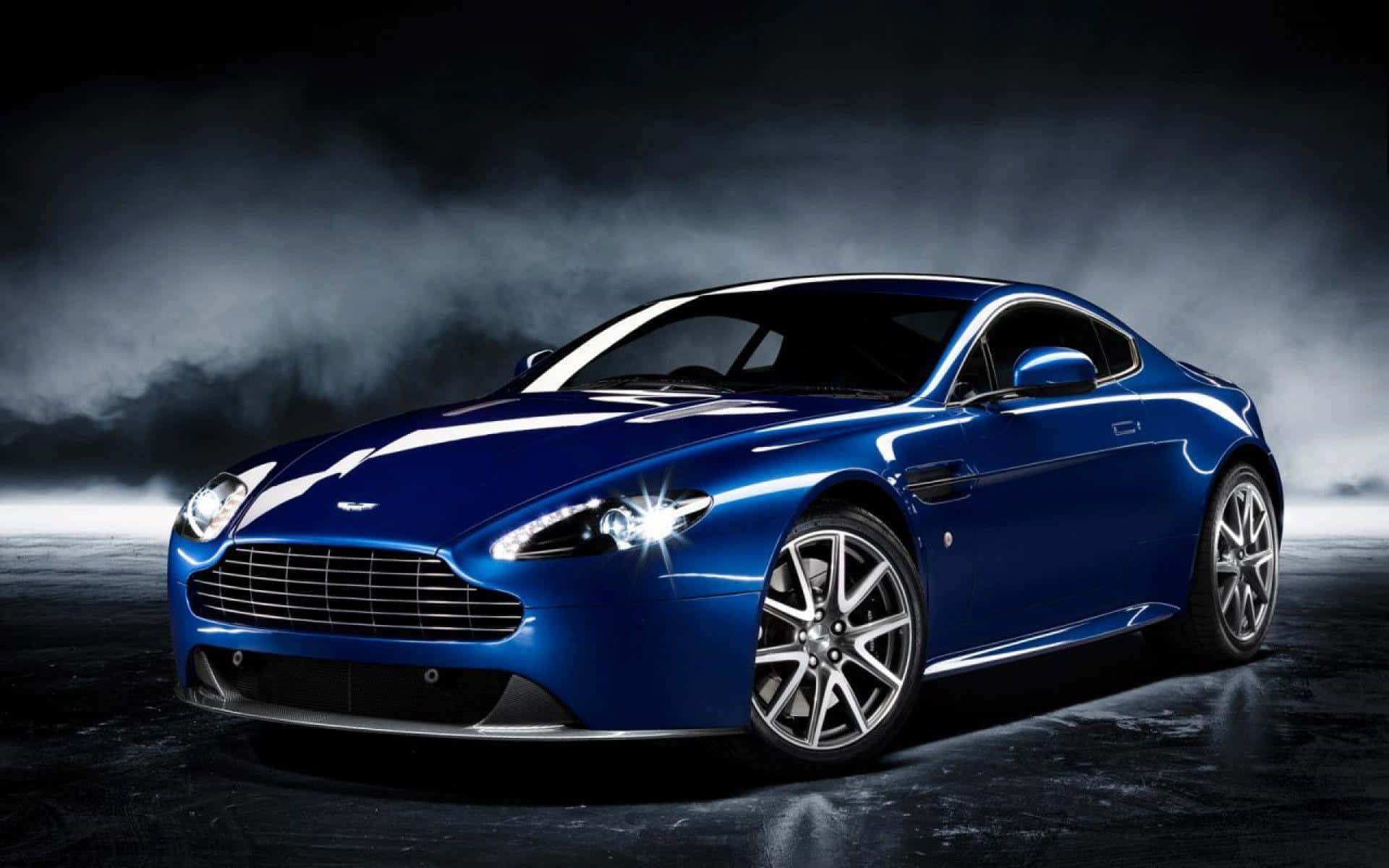 Fantastisk Aston Martin DB9 i bevægelse på en naturskøn rute Wallpapers
