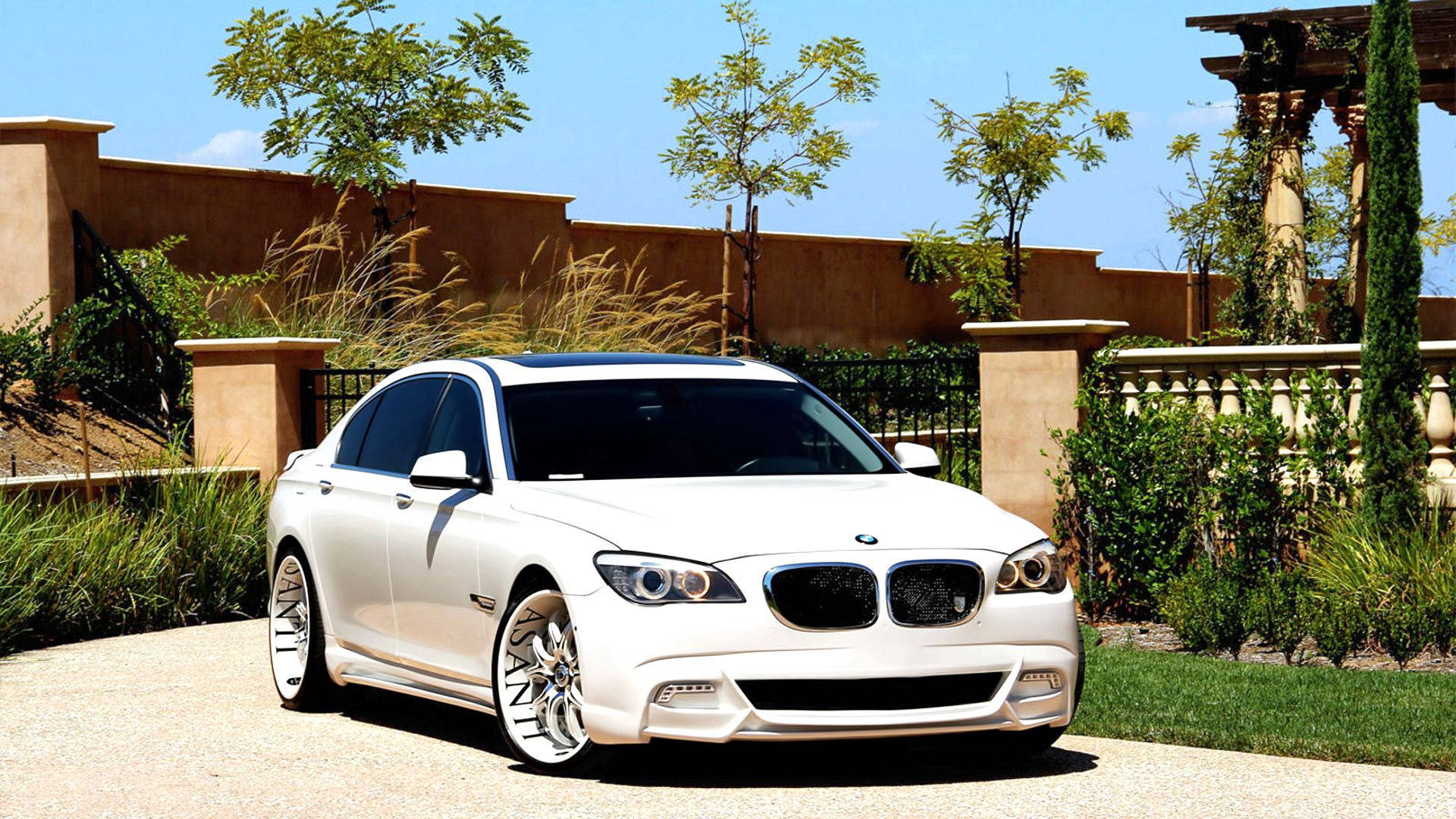 Hvid BMW 7 F01 bil med Asanti tuning ved port tapet — Bmw Wallpapers
