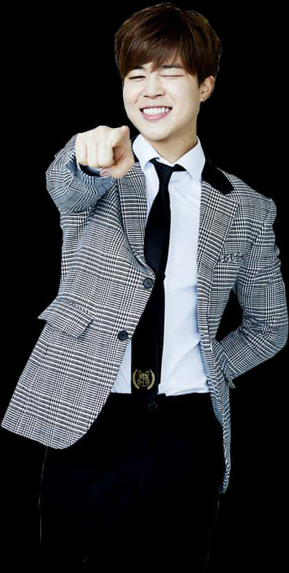 Smilende mand i ternet blazer peger fremad Wallpapers