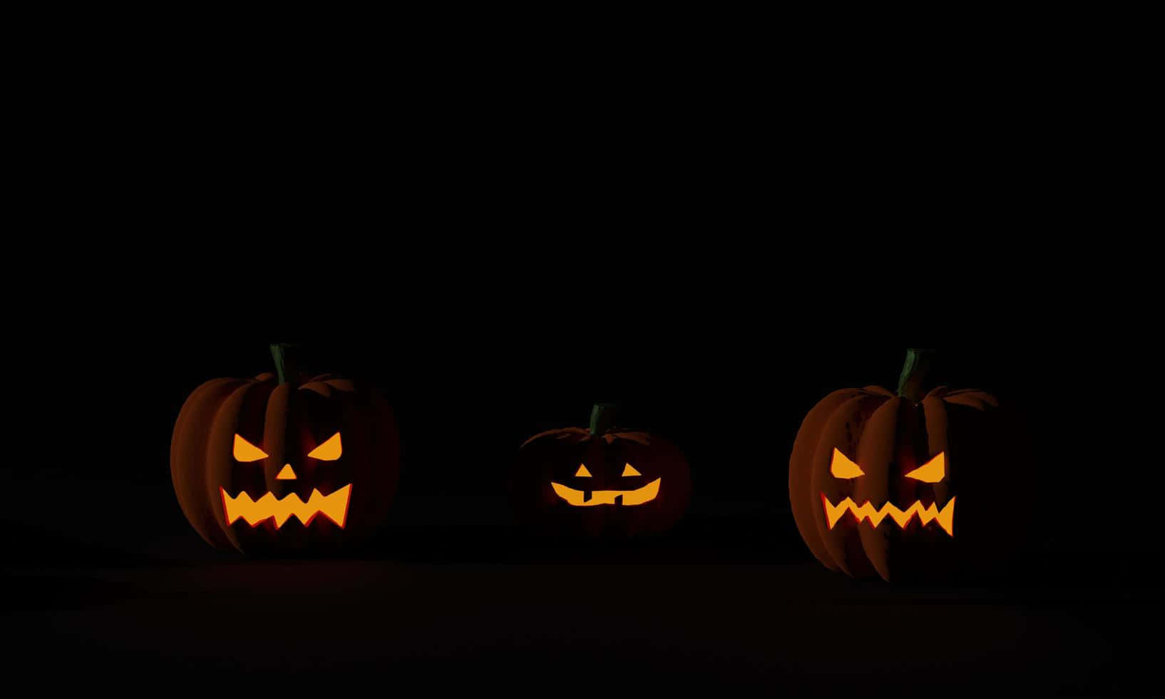 Tre Halloween-græskar baggrund mørk Wallpapers