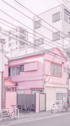 Lyserødt æstetisk hjem ved siden af hvid bygning — Pastel pink æstetik Wallpapers